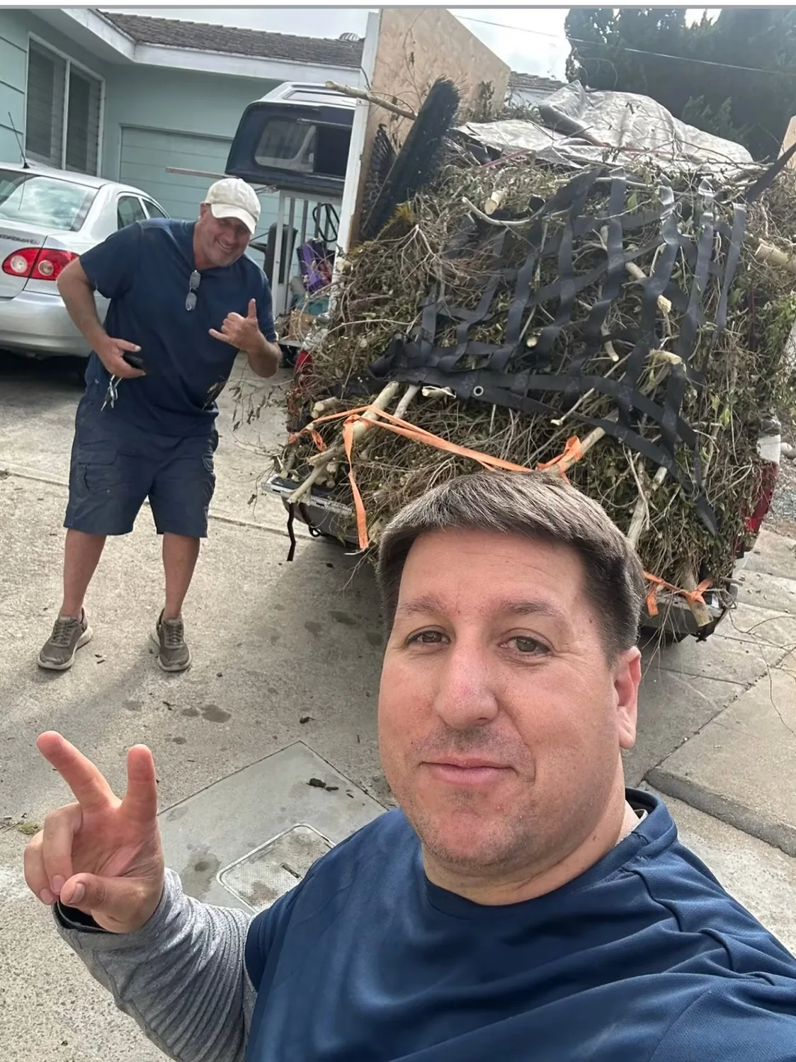 Joe and a Rancho Removal helper with a loaded yard-debris trailer in San Diego